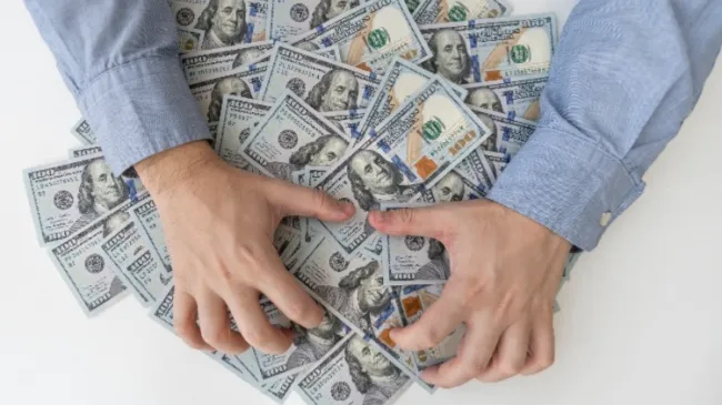 man grabbing cash